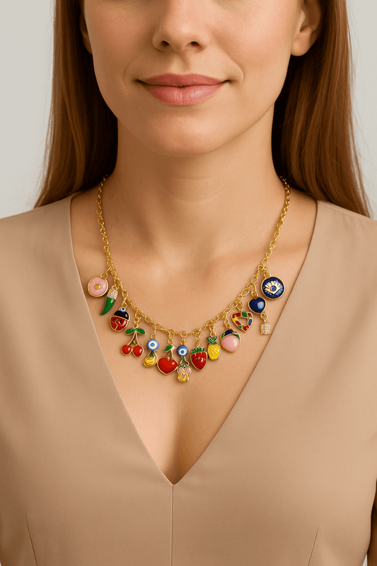 Collier a personnaliser featuring colorful fruit charms worn by a model with a neutral top.